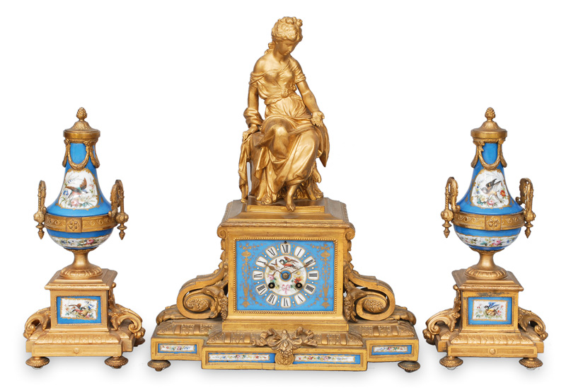 A three-piece-set for the fireplace with a pendulum clock