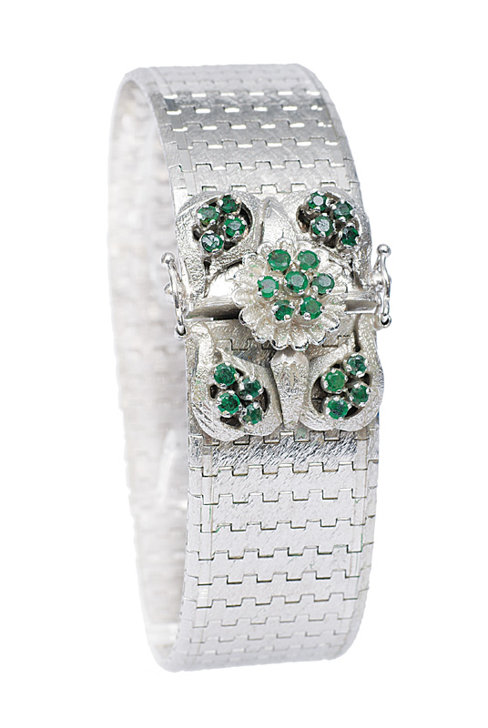 A white gold bracelet with emerald clasp