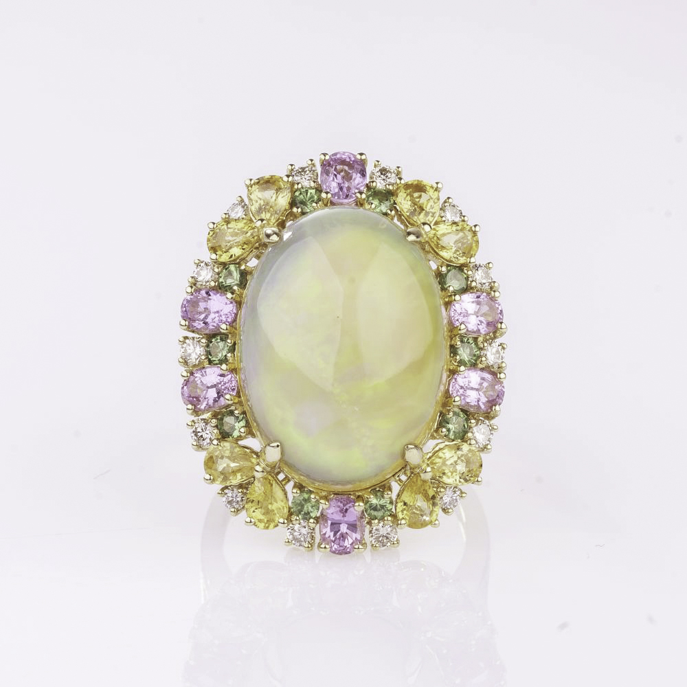 A large Opal Ring with colourful Sapphires and Diamonds