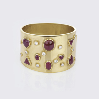 A wide Gold Bangle with Ruby and Diamond Setting